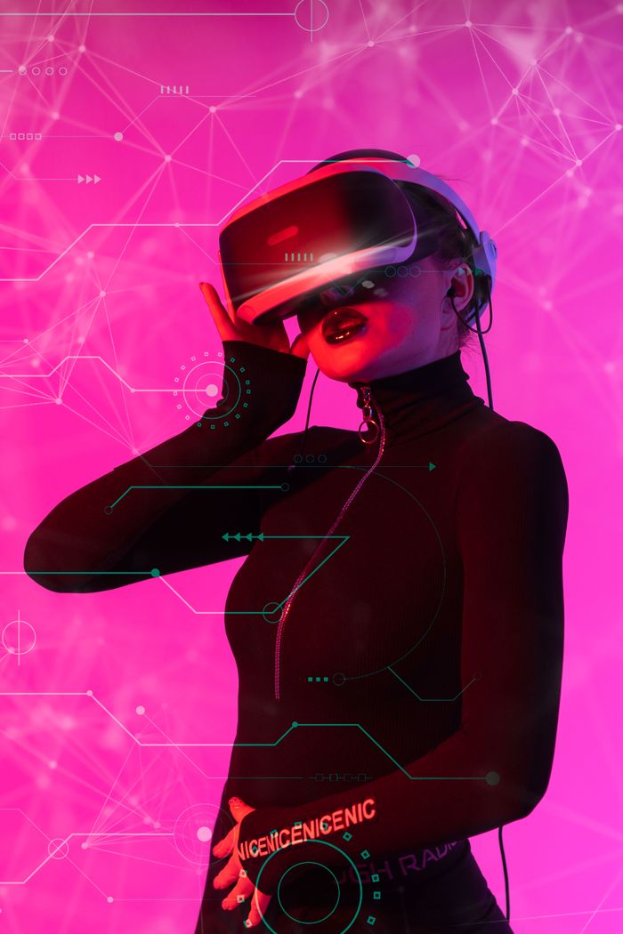 The Art of Drawing Readers In: Your attractive post title goes here Woman wearing VR headset in a futuristic digital environment with pink cyber graphics.